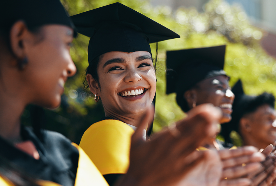 High school graduates clapping during ceremony