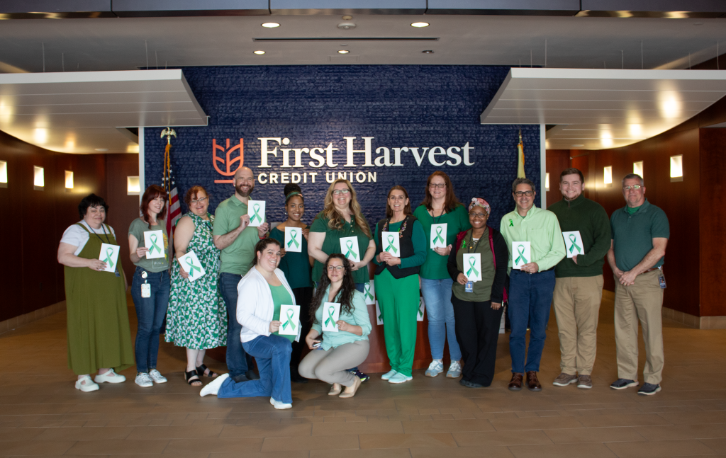 First Harvest employees dressed in green to show support during Mental Health Awareness Month.
